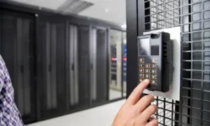 Person entering a security code on an electronic access control keypad at a secured entrance.