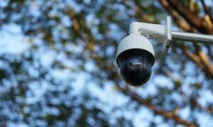 Outdoor dome security camera mounted on a pole for property surveillance and monitoring.